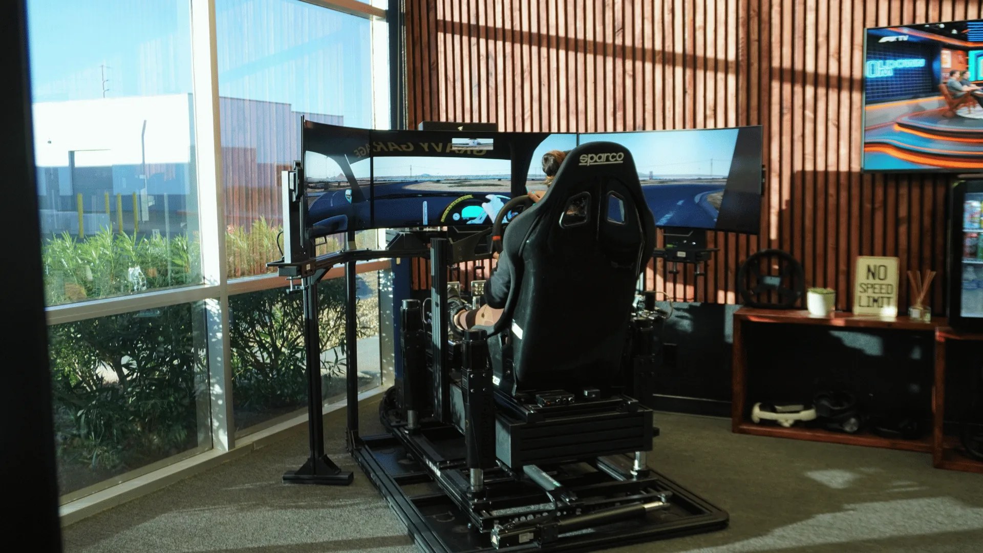 Teen birthday group smiles while racing professional simulator cockpits in Las Vegas